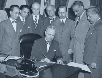 PRESIDENT TRUMAN SIGNING THE LUCE-CELLAR ACT 1946